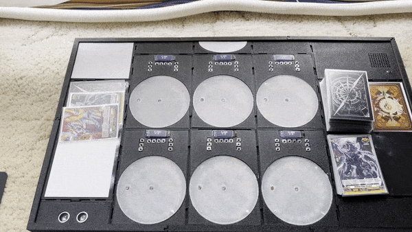 User places cards on a playmat which lights up in response.
